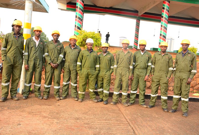 AKS site crew in safety helmets and coveralls